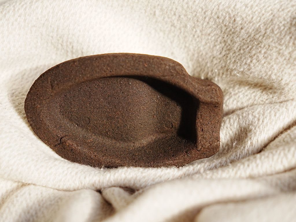 Early shoe tree prototype pressed from coffee grounds
