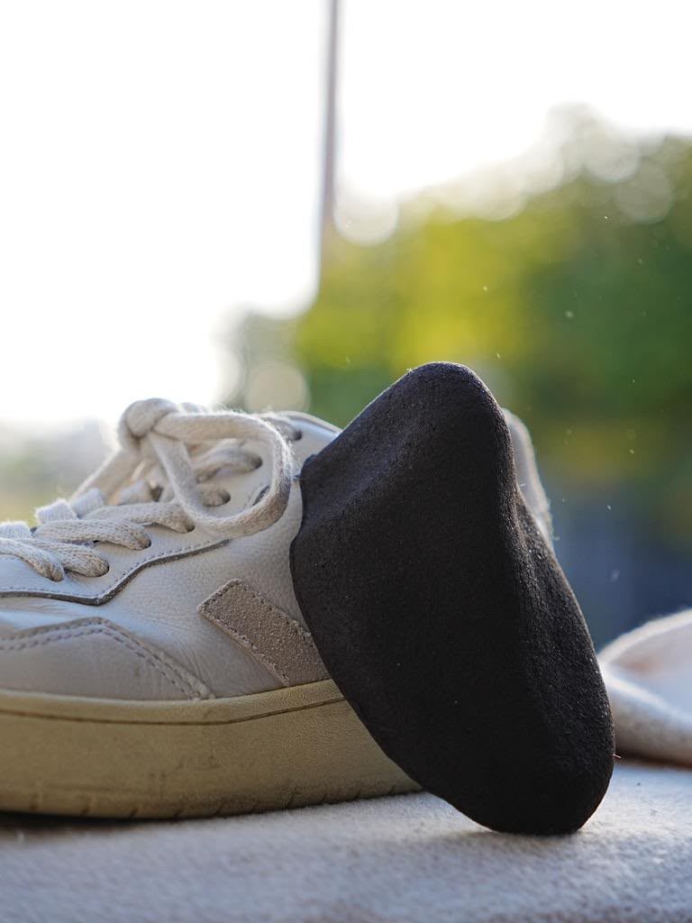 Kahyve shoe tree placed inside a white sneaker